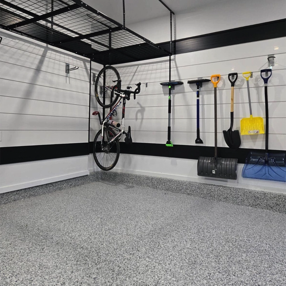 Epoxy flooring in garage with slatwall storage.